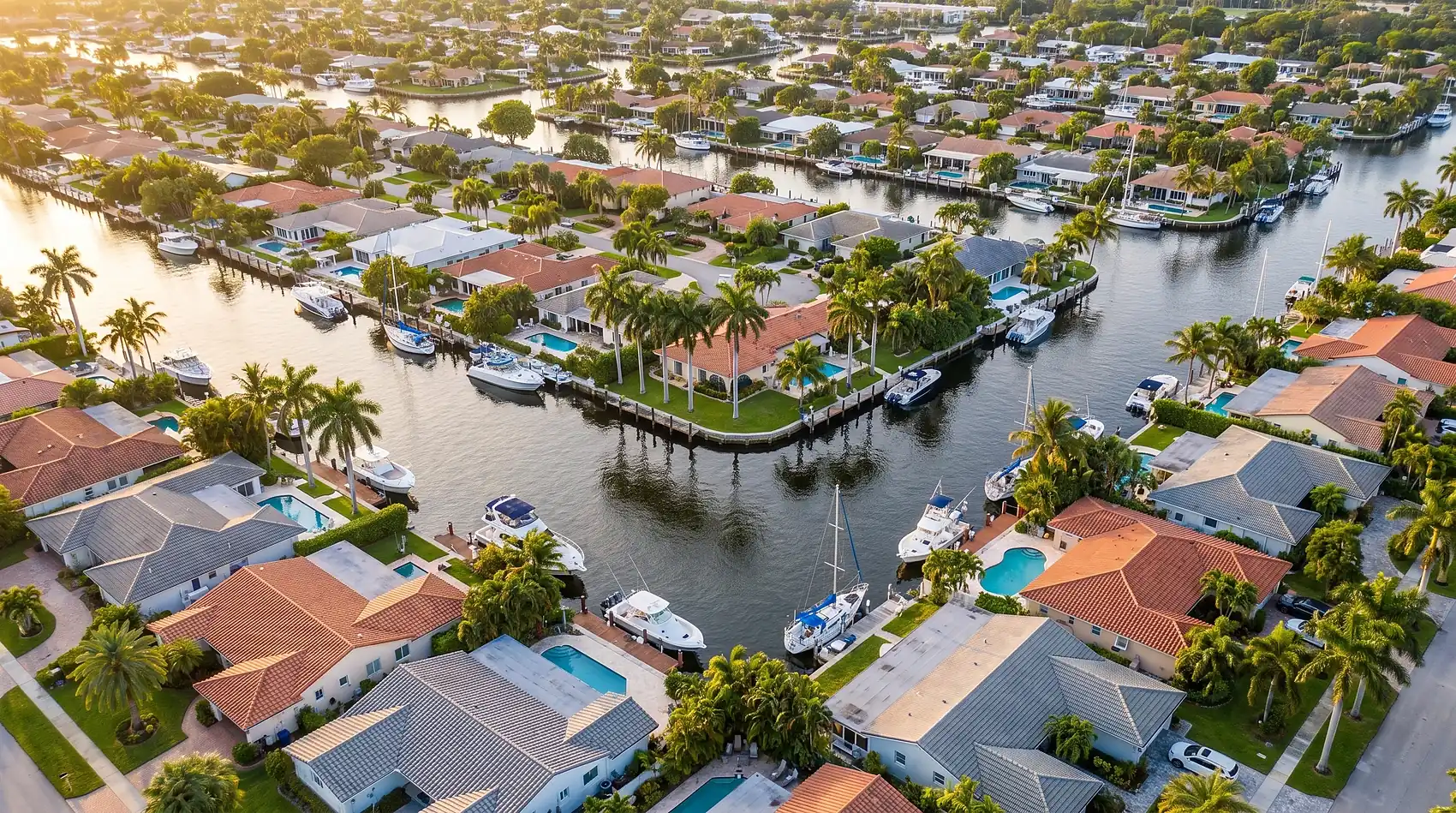 Aerial view of a Fort Lauderdale canal neighborhood of tile roofs