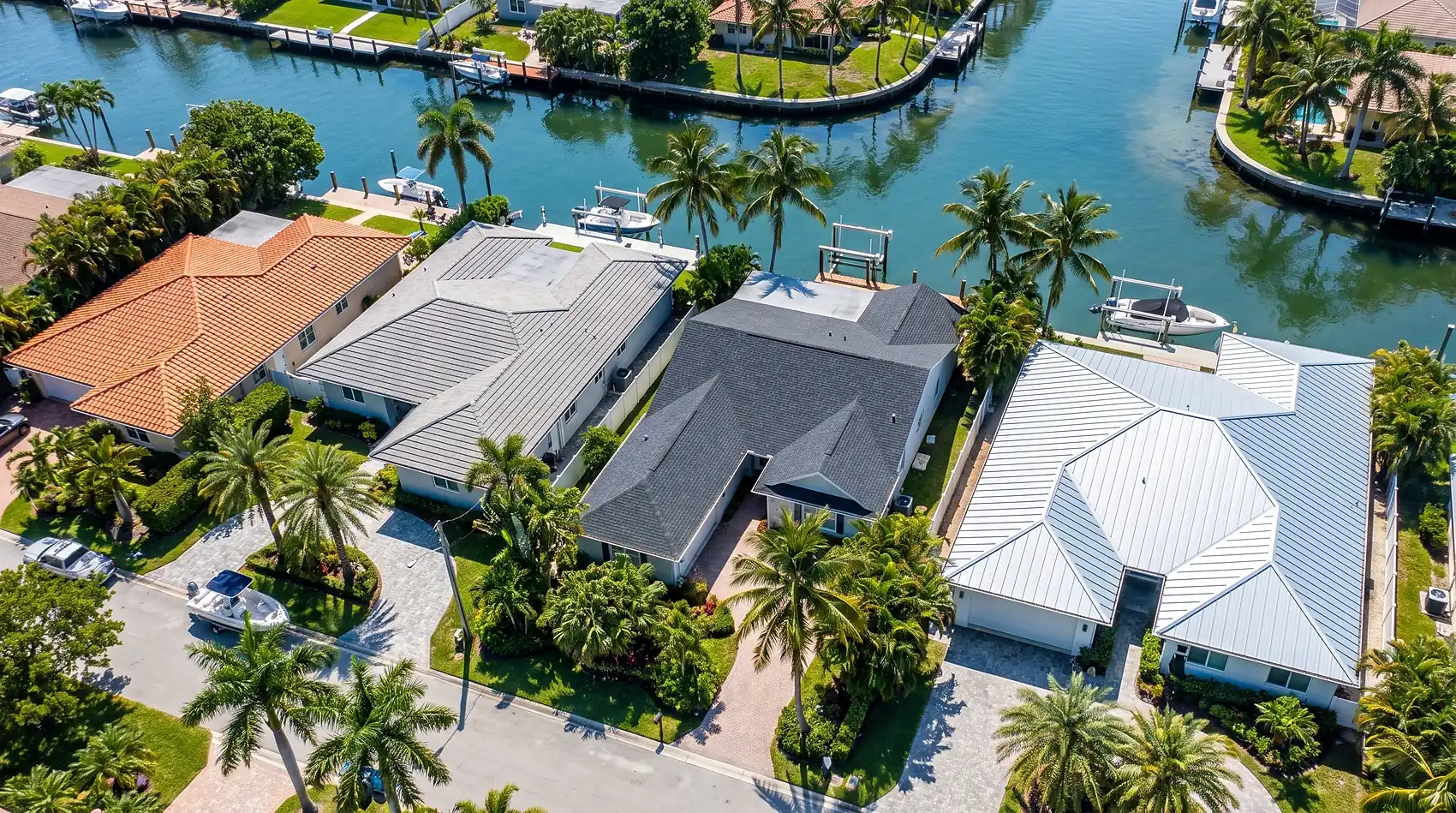 Barrel tile, flat tile, shingle and metal roofs side by side in one neighborhood