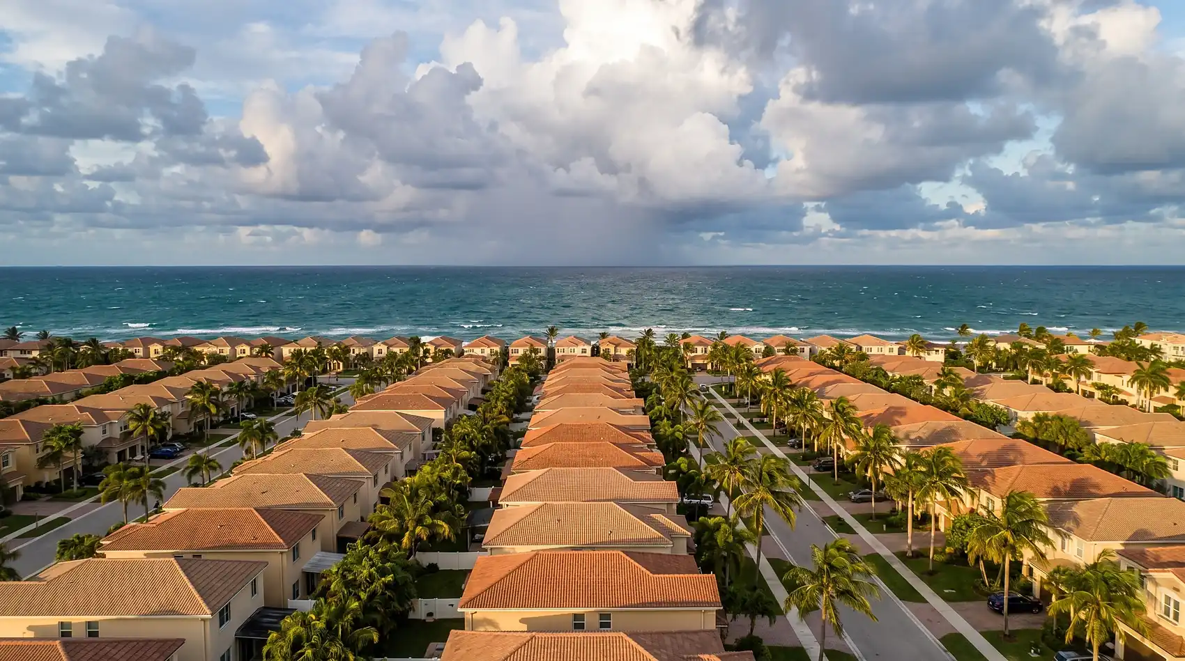 South Florida tile rooftops under a building storm sky