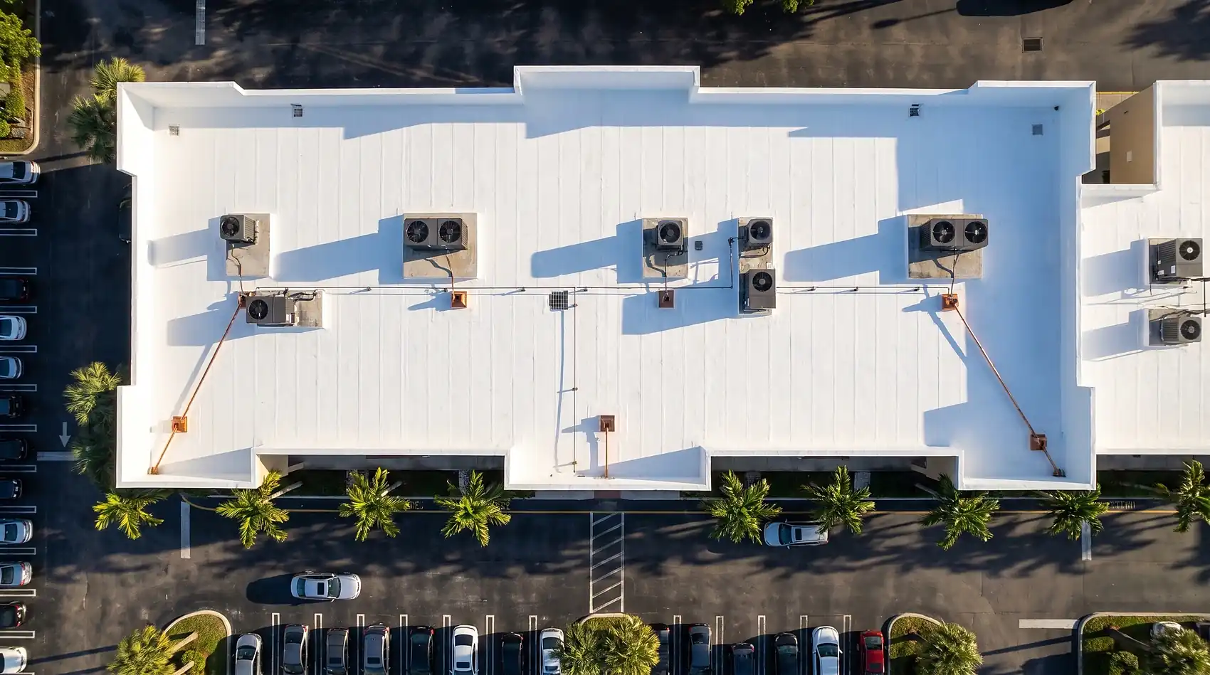 Restored flat commercial roof with a reflective silicone coating, from the air